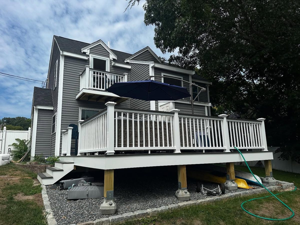 Back left corner after the re-side, with new deck and balcony rails